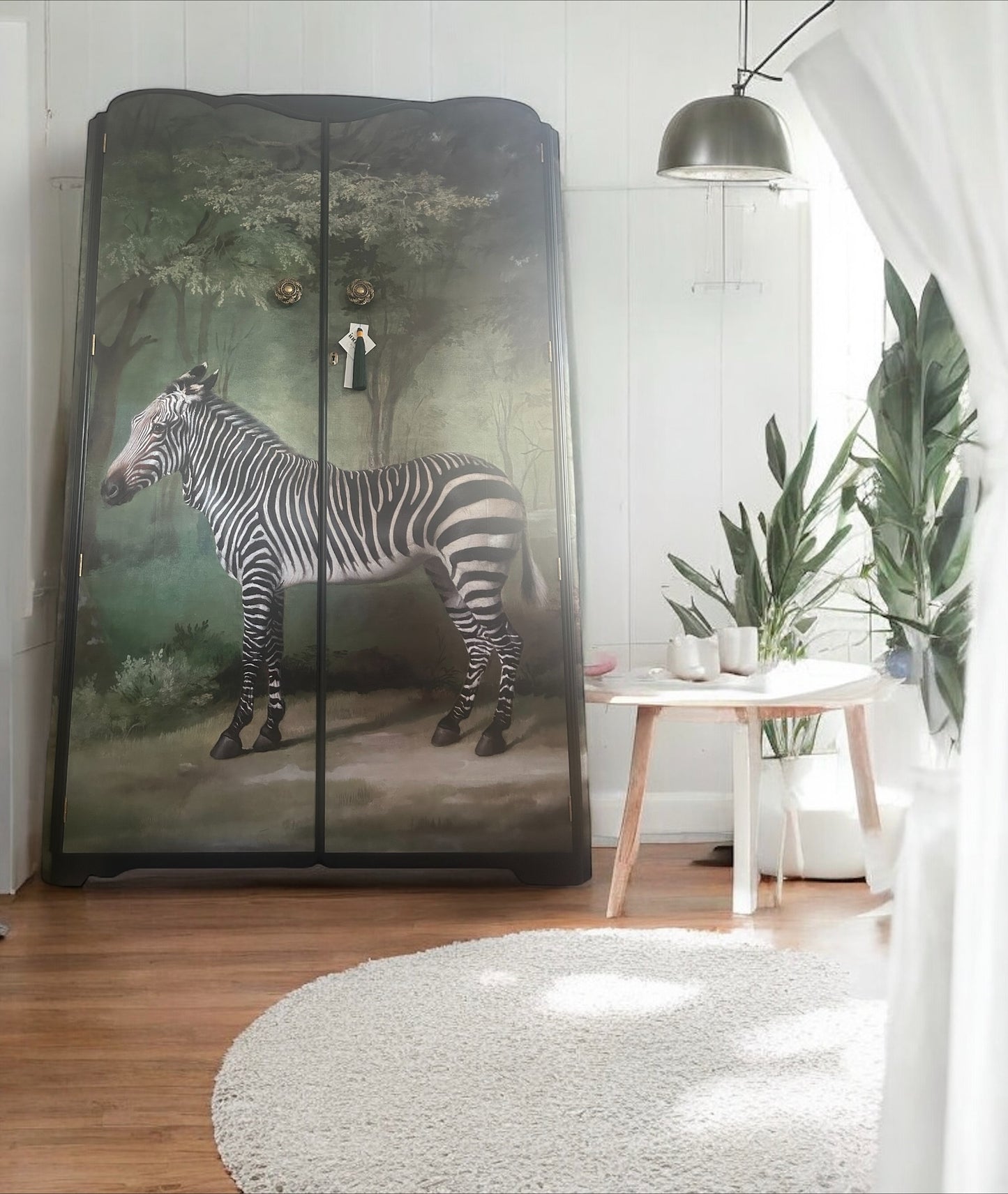 Cabinet with zebra design in a room with plants and a table.