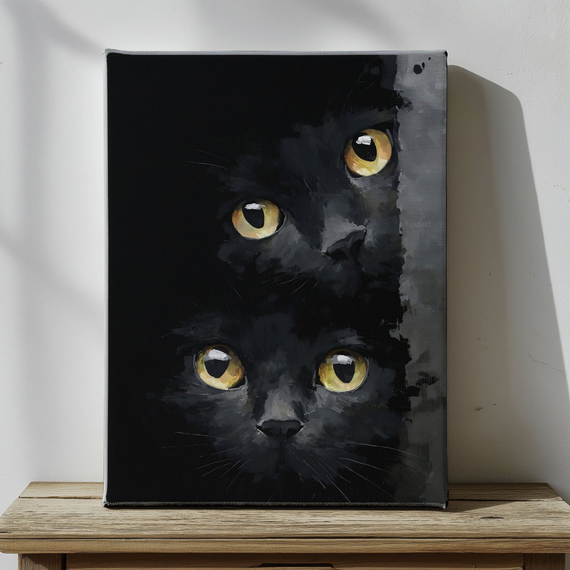 Canvas print of a black cat with yellow eyes on a wooden surface.