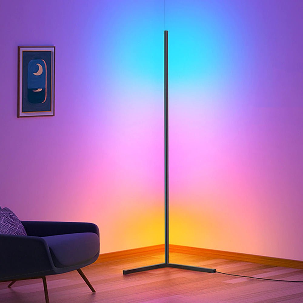 Colorful gradient wall with a standing lamp casting light on a modern chair.