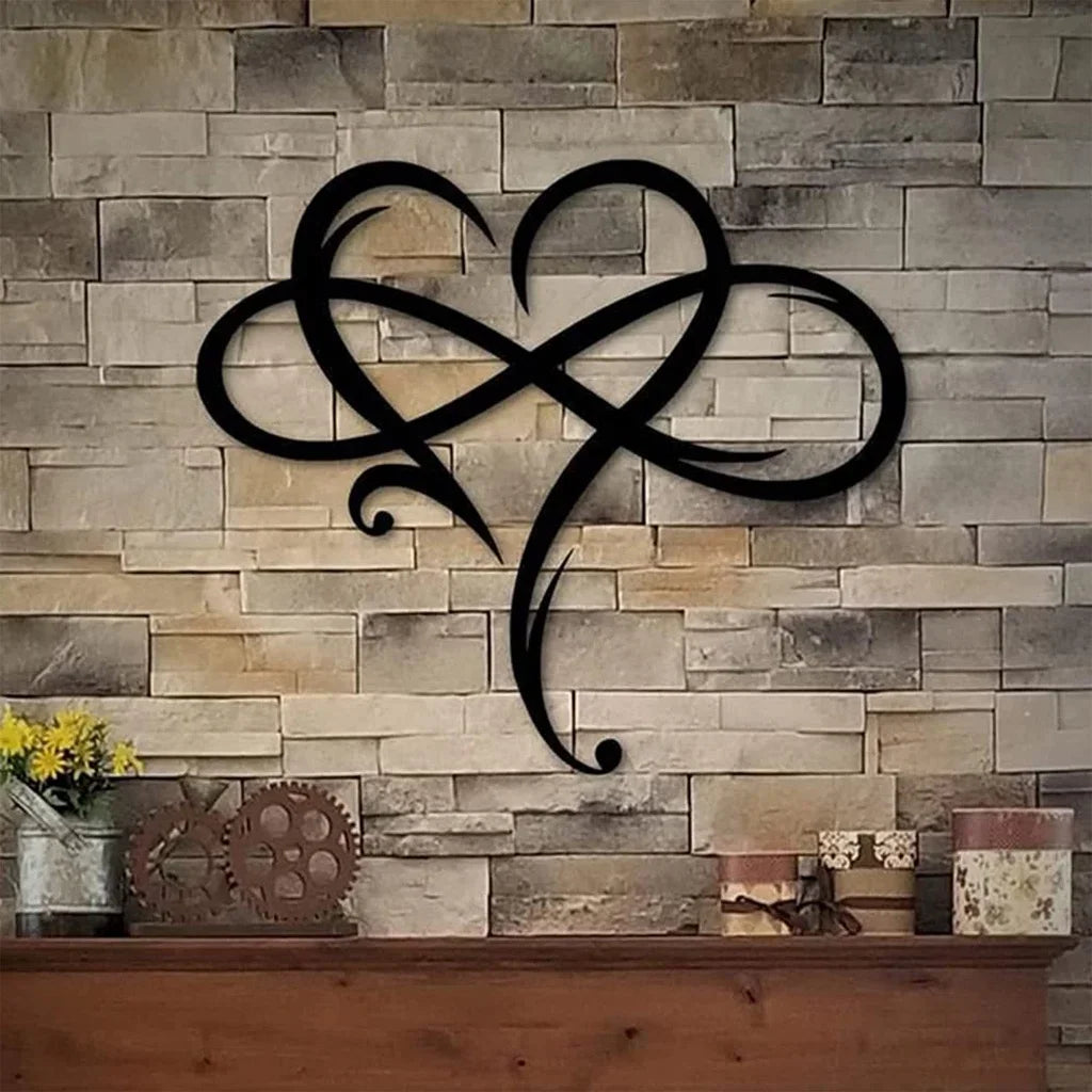 Black infinity symbol on a stone wall with decorative items below