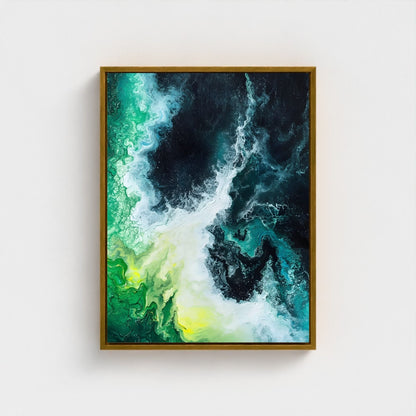 Framed abstract artwork with green, black, and yellow colors on a white wall.