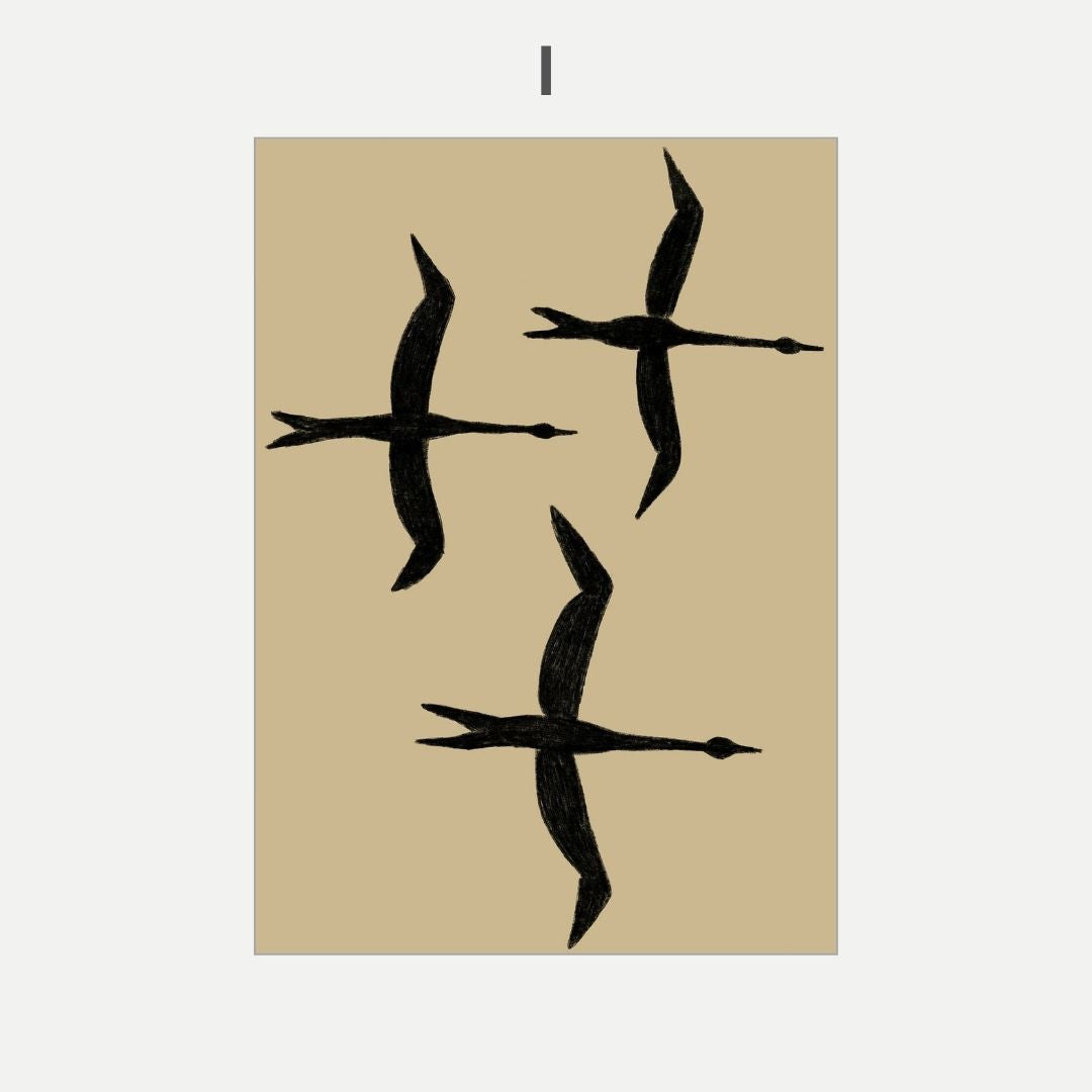 Three black swan silhouettes on a beige background