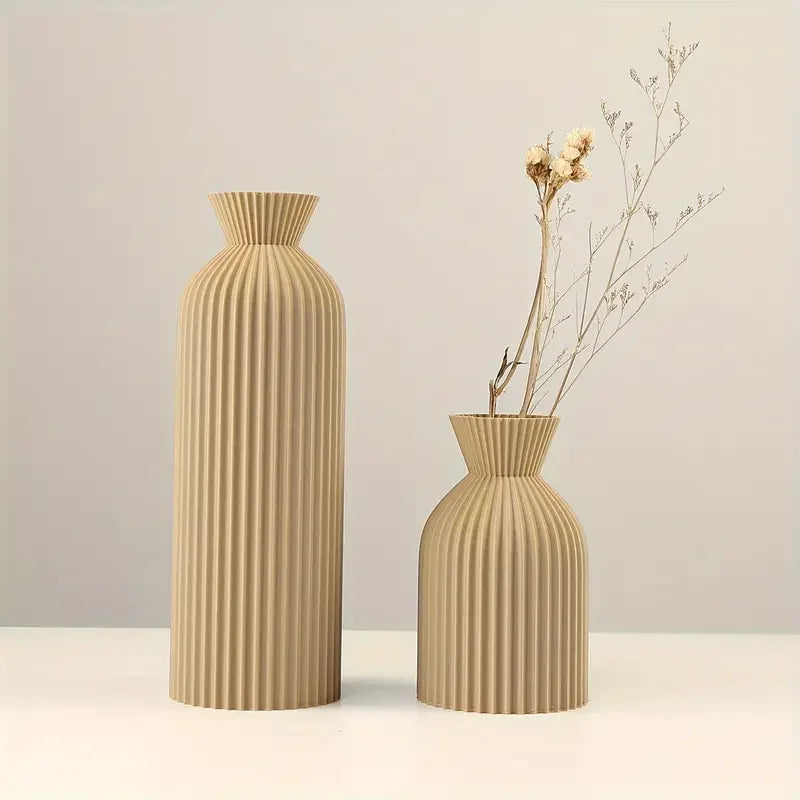 Two beige textured vases on a light background