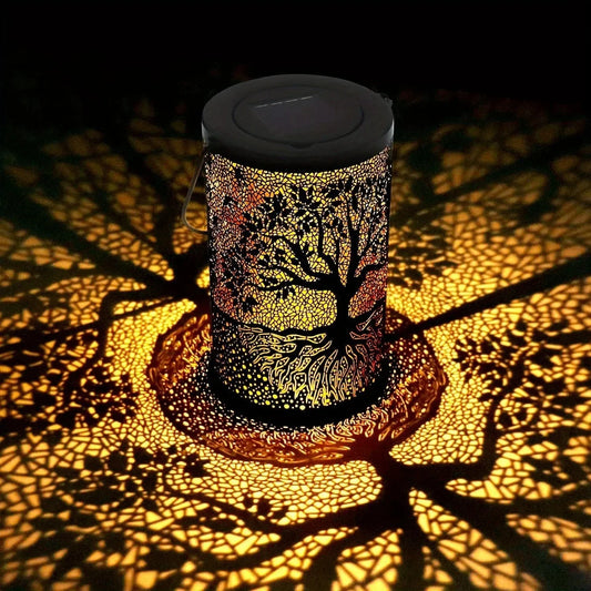 Decorative lamp casting tree shadows on a dark background