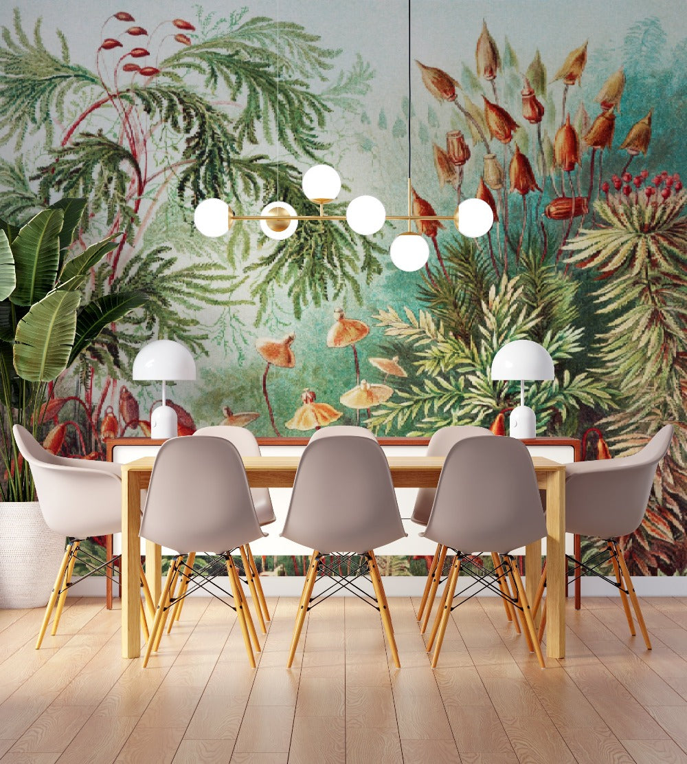 Mural wall decoration featuring luxuriant vegetation of jungle, a rich variety of plants and flowers wallpaper in green, red and yellow soft colors