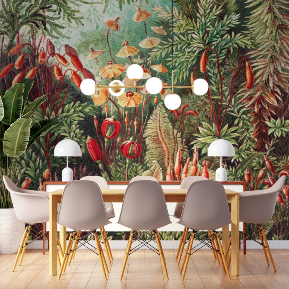 Mural wall decoration featuring luxuriant vegetation of jungle, a rich variety of plants and flowers wallpaper in green, red and yellow soft colors